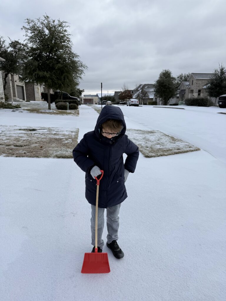 Cleaning ice and snow from the driveway